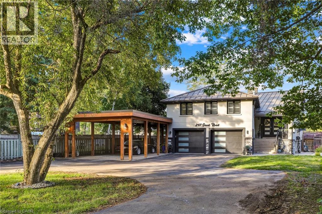 Contemporary two-story exterior featuring a metal roof, light-toned stucco siding, and stone accents - 247 Sand Road, Holland Landing, ON - Outdoor