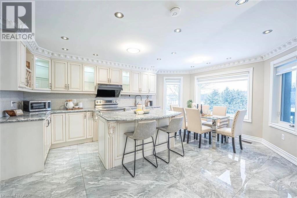 Eat-in kitchen featuring white cabinetry, granite countertops, stainless steel appliances, and tile flooring - 247 Sand Road, Holland Landing, ON - Indoor