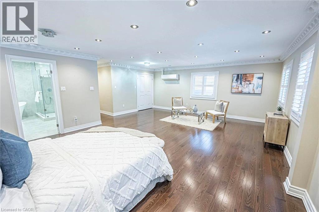 Spacious interior featuring dark wood-finish flooring, recessed lighting, crown molding, and white window shutters - 247 Sand Road, Holland Landing, ON - Indoor