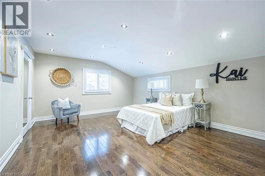 Spacious room featuring wood-finish flooring, recessed lighting, and a sloped ceiling - 247 Sand Road, Holland Landing, ON - Indoor Photo Showing Bedroom