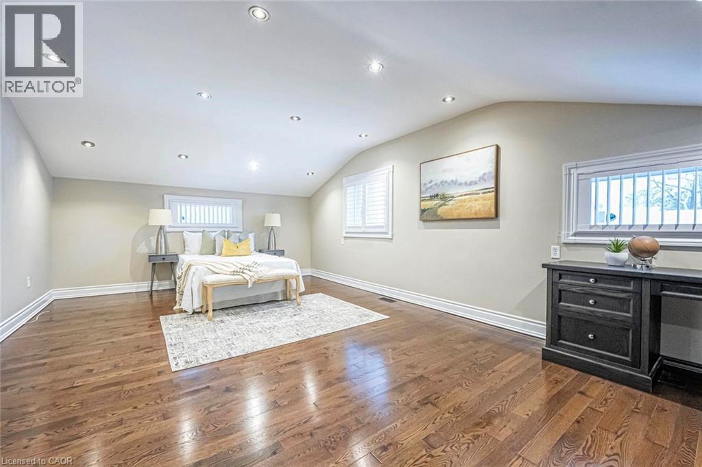 Spacious room featuring rich wood-finish flooring, recessed lighting, and multiple windows with plantation shutters - 247 Sand Road, Holland Landing, ON - Indoor