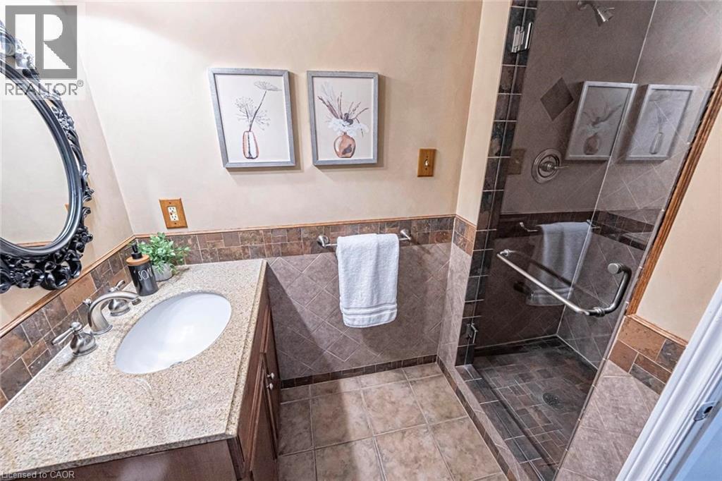 Bathroom featuring a single vanity with a granite-style countertop, undermount sink, and brushed nickel fixtures - 247 Sand Road, Holland Landing, ON - Indoor Photo Showing Bathroom