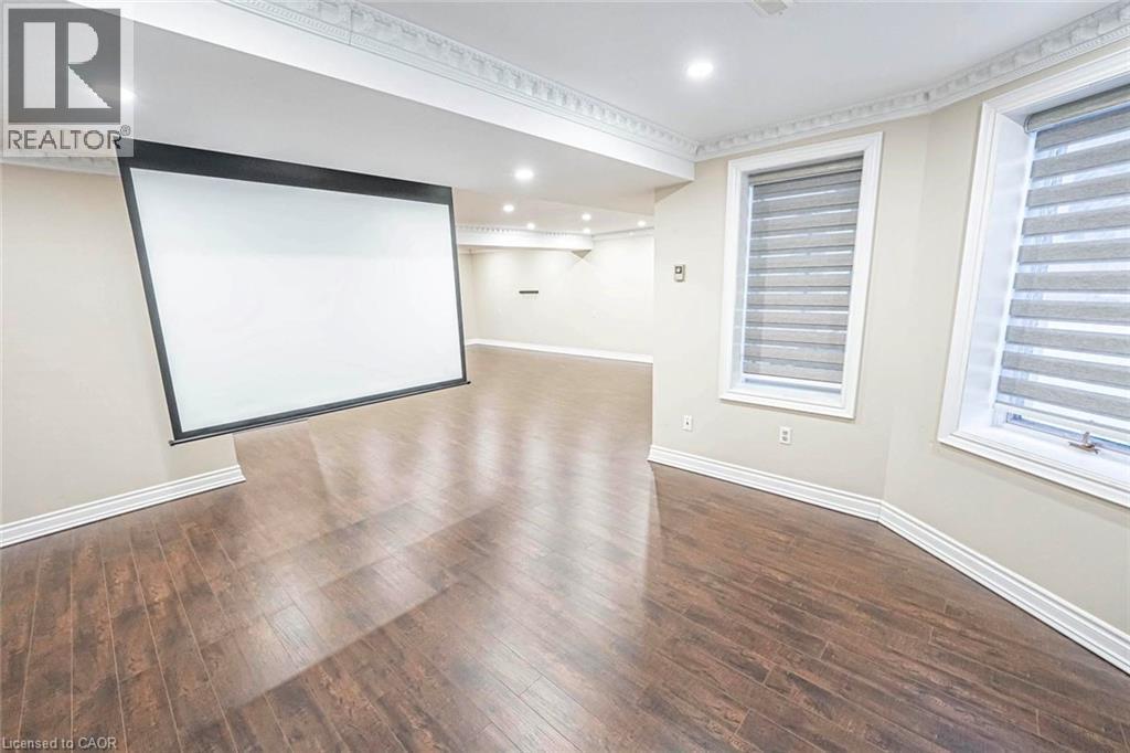 Spacious room featuring a large retractable projection screen, recessed lighting, and wood-finish flooring - 247 Sand Road, Holland Landing, ON - Indoor Photo Showing Other Room