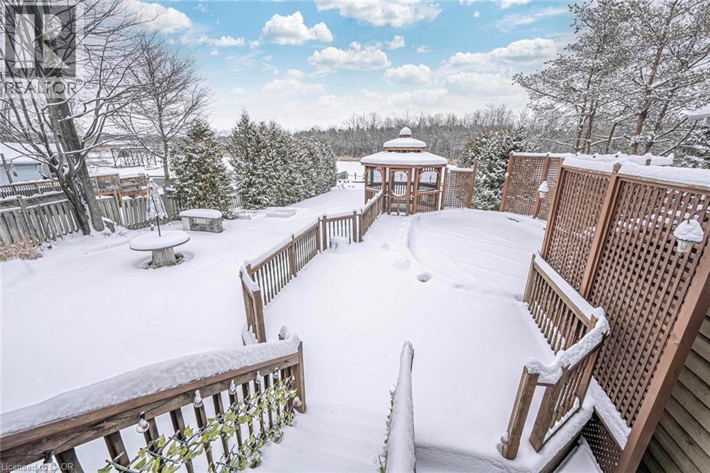 Spacious outdoor decking with wood railings and privacy screens overlooking a snow-covered yard with mature trees - 247 Sand Road, Holland Landing, ON - Outdoor With Deck Patio Veranda