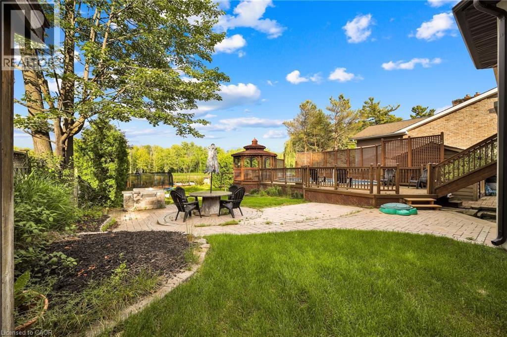 Spacious backyard featuring a multi-level wood deck, a prominent gazebo, and a stone-paved patio with a built-in stone fire pit - 247 Sand Road, Holland Landing, ON - Outdoor