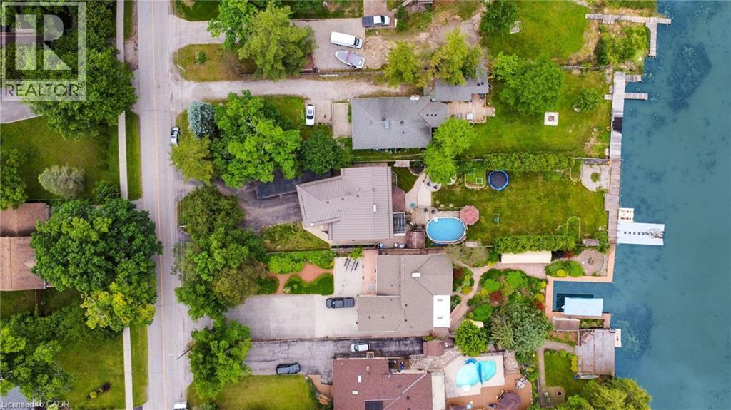Waterfront property featuring a private dock, expansive green space, and a swimming pool - 247 Sand Road, Holland Landing, ON - Outdoor With Body Of Water With View