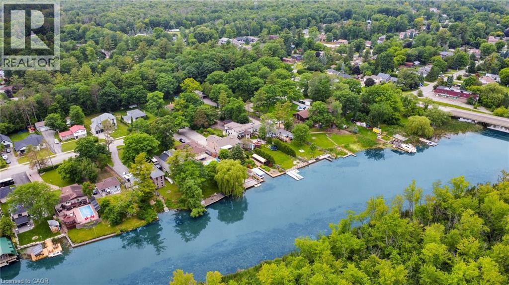 Waterfront properties with private docks, lush green surroundings, and mature trees lining the riverbank - 247 Sand Road, Holland Landing, ON - Outdoor With Body Of Water With View