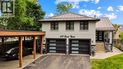 Contemporary stucco facade featuring a metal roof and an attached carport -