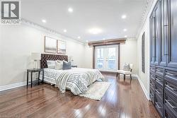 Bedroom featuring dark wood-finish flooring, recessed lighting, and crown molding -