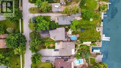 Waterfront property featuring a private dock, expansive green space, and a swimming pool -