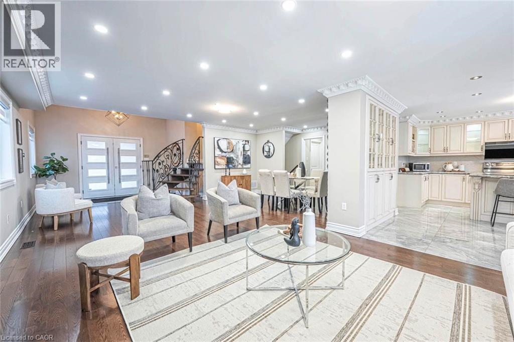 Open-concept living area featuring rich wood-finish flooring, recessed lighting, and ornate crown molding - 247 Sand Road, Holland Landing, ON - Indoor