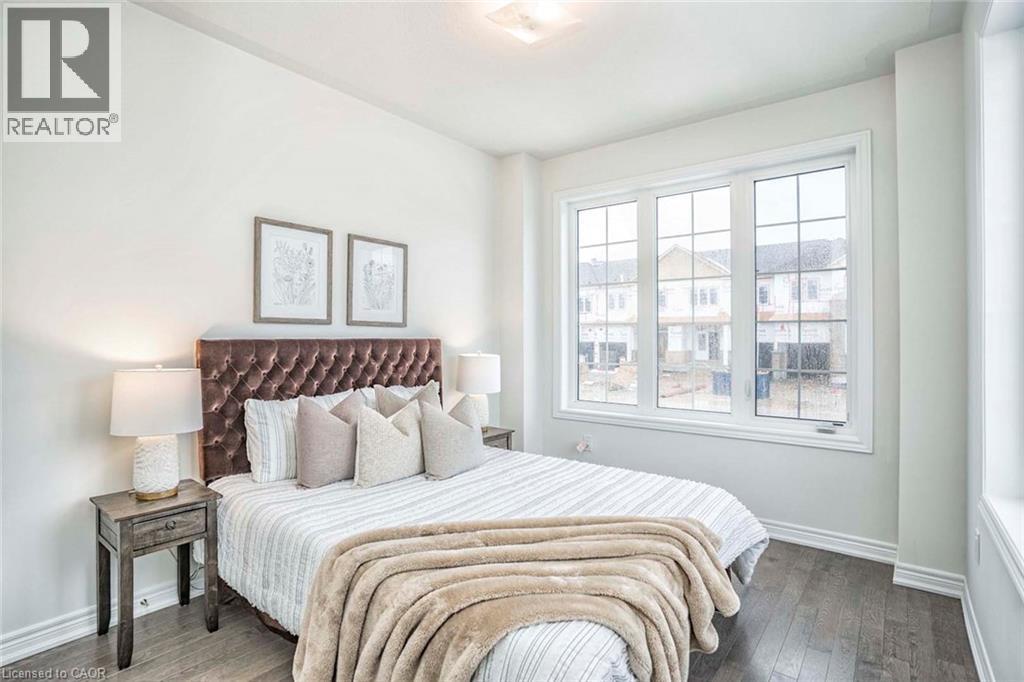 Hardwood-finish flooring, white painted walls, multi-pane window, flush mount ceiling light - 525 Red Elm Road, Shelburne, ON - Indoor Photo Showing Bedroom