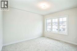 Neutral wall finishes, plush carpet flooring, recessed lighting, and a multi-pane window -