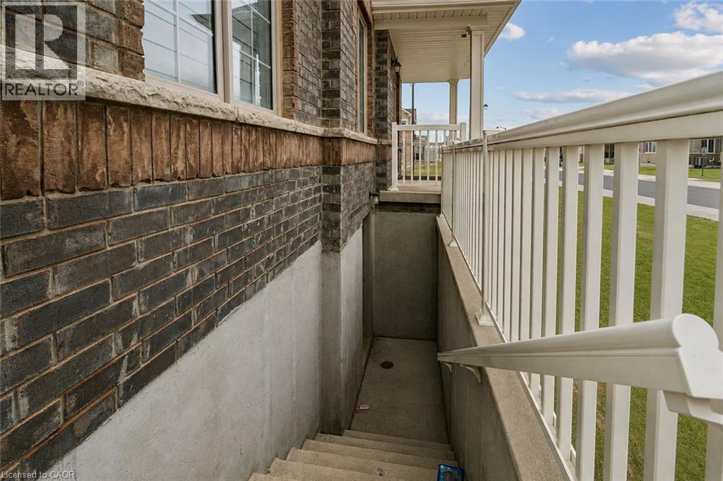 Exterior brick facade with a stone window sill and concrete foundation - 525 Red Elm Road, Shelburne, ON - Outdoor With Exterior