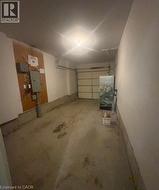Attached garage featuring a concrete floor and overhead lighting - 