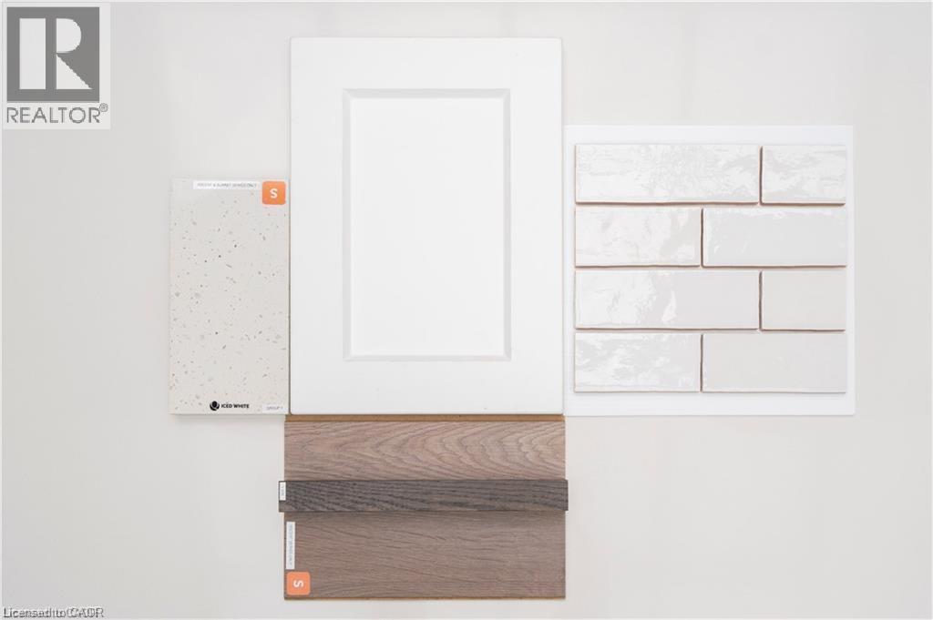 White flat panel cabinetry, light speckled countertop material, white rectangular subway tile, and wood-finish flooring samples - 443 Benninger Drive, Kitchener, ON - Other