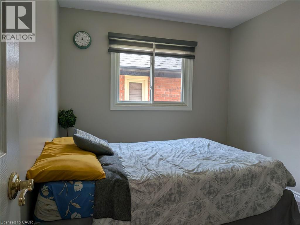 White framed window with privacy blinds - 45 Caswell Drive Unit# Upper, Hamilton, ON - Indoor Photo Showing Bedroom