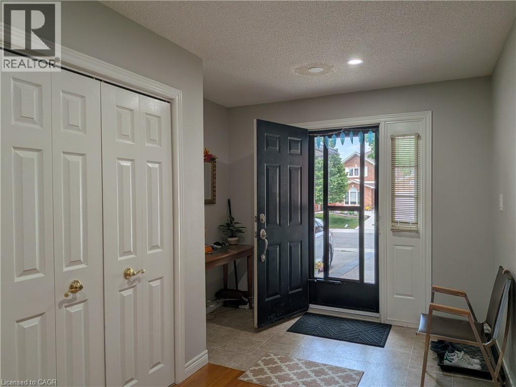 Entryway featuring tile flooring, a six-panel front door with a screen door, and a sidelight with blinds - 45 Caswell Drive Unit# Upper, Hamilton, ON - Indoor Photo Showing Other Room