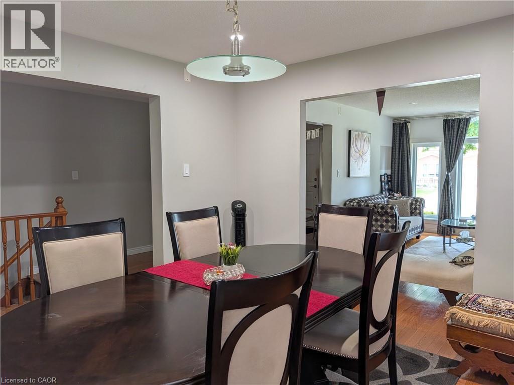 Recessed ceiling lighting, wood-finish flooring, and a staircase with wood railing - 45 Caswell Drive Unit# Upper, Hamilton, ON - Indoor Photo Showing Dining Room