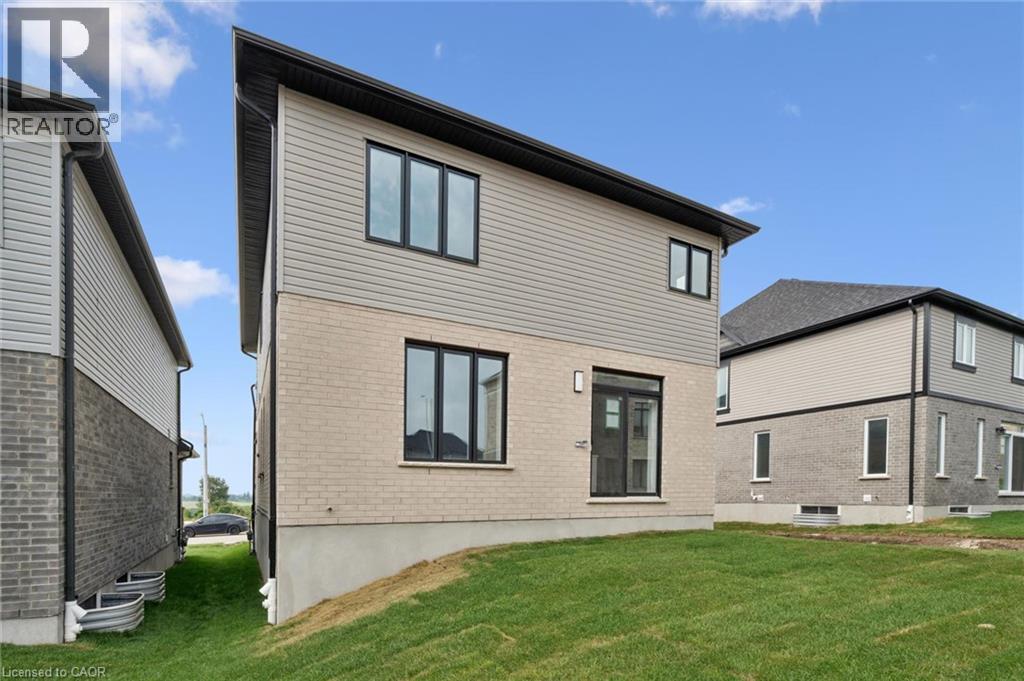 Contemporary exterior design featuring a light brick facade and horizontal siding - 451 Benninger Street, Kitchener, ON