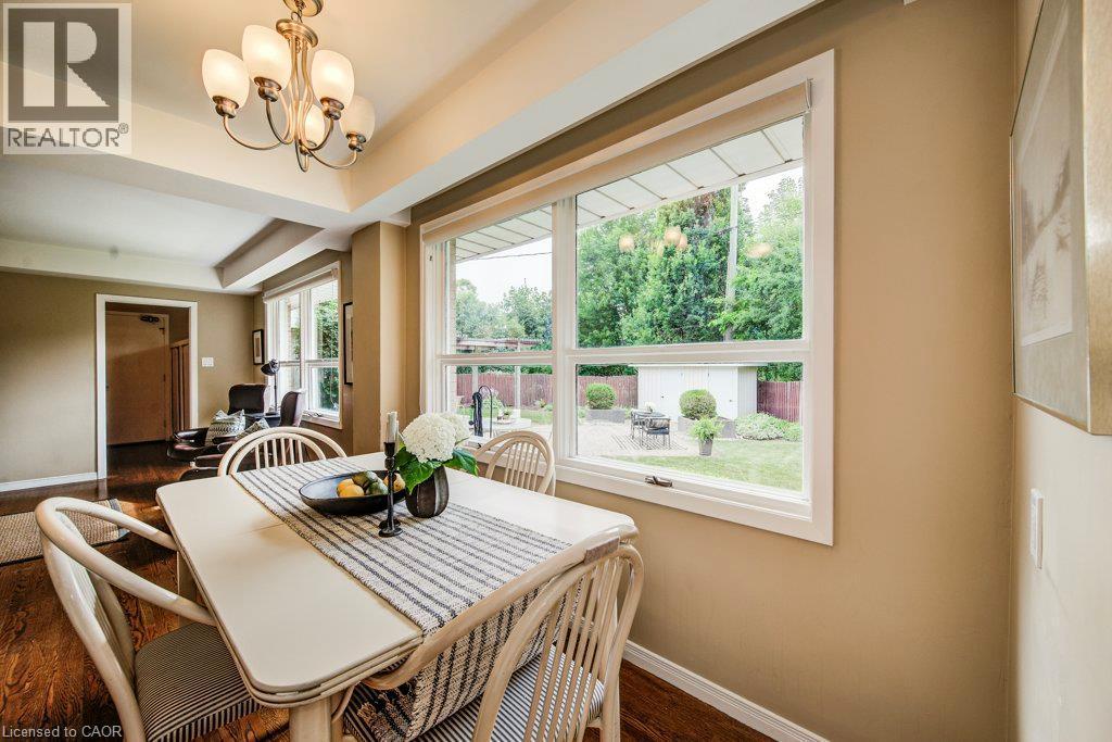 Dining area featuring wood-finish flooring and a multi-bulb chandelier - 97 Somerset Crescent, Waterloo, ON - Indoor Photo Showing Dining Room