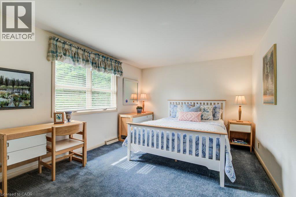 Carpeted room with a large window featuring horizontal blinds - 97 Somerset Crescent, Waterloo, ON - Indoor Photo Showing Bedroom