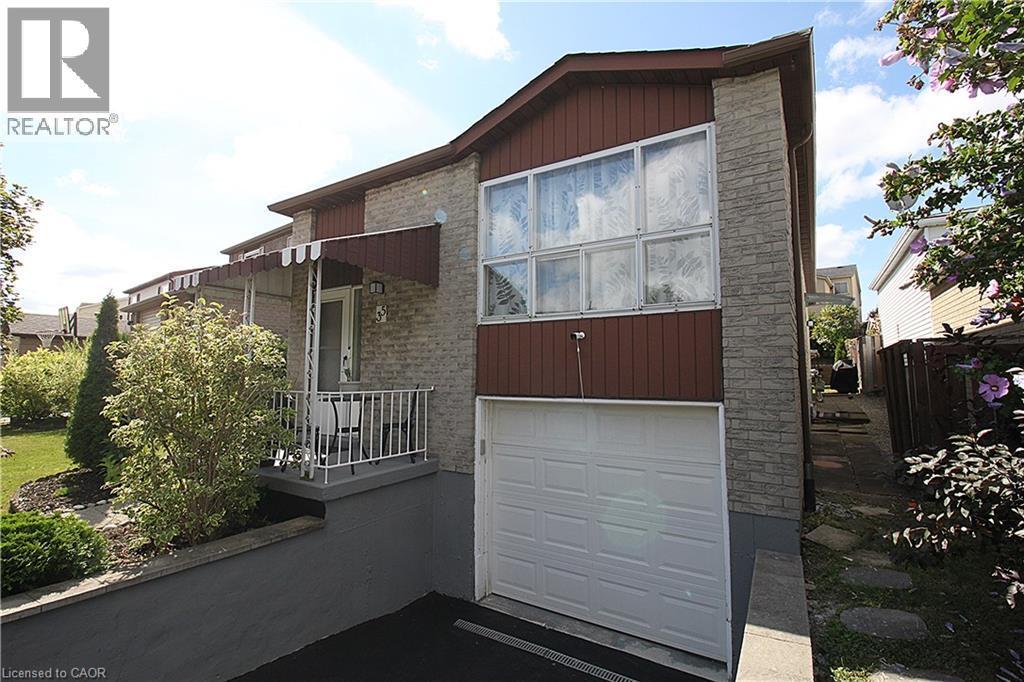 Brick exterior with brown siding accents, attached garage, covered front entry, and mature landscaping - 35 Garden Crescent, Hamilton, ON - Outdoor With Exterior