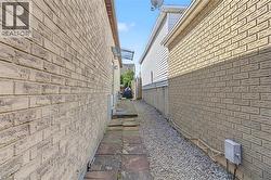 Brick exterior with a partial privacy fence and an awning over a doorway - 