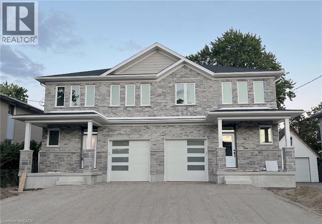 Stone and brick facade with multiple windows, covered entryways, and modern garage doors - 81 Second Avenue Unit# B, Kitchener, ON - Outdoor With Facade