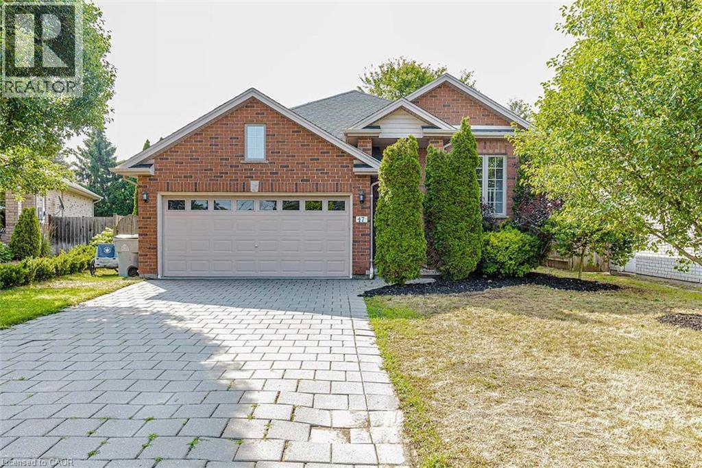 Brick-clad exterior with a prominent attached garage - 47 Queensway Drive, Strathroy, ON - Outdoor
