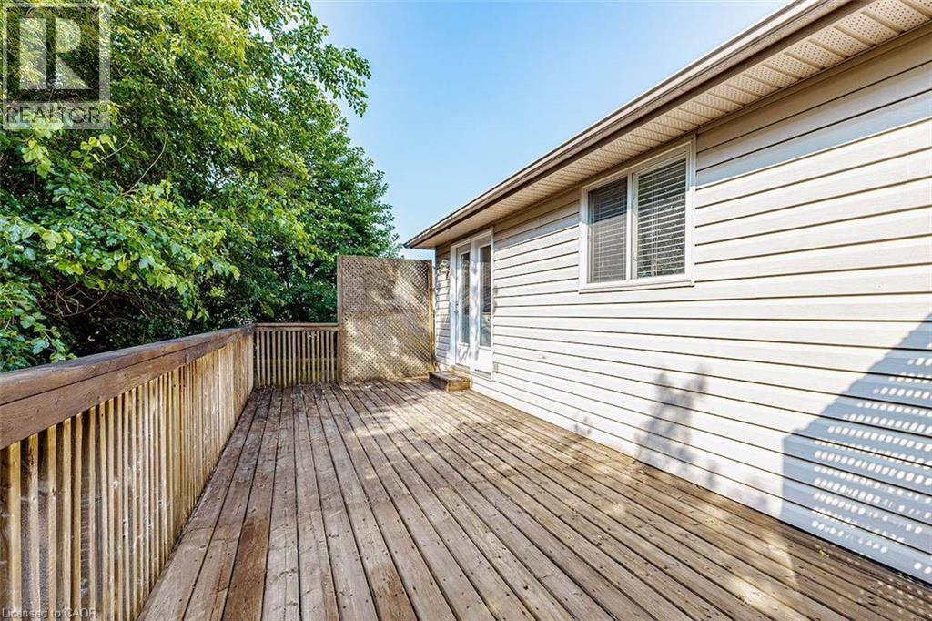 Spacious wood-finish deck with privacy lattice and railing - 47 Queensway Drive, Strathroy, ON - Outdoor With Deck Patio Veranda With Exterior