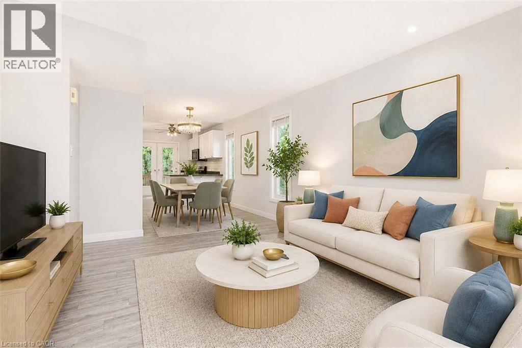Open-concept living area with wood-finish flooring, recessed lighting, and ample natural light - 47 Queensway Drive, Strathroy, ON - Indoor Photo Showing Living Room