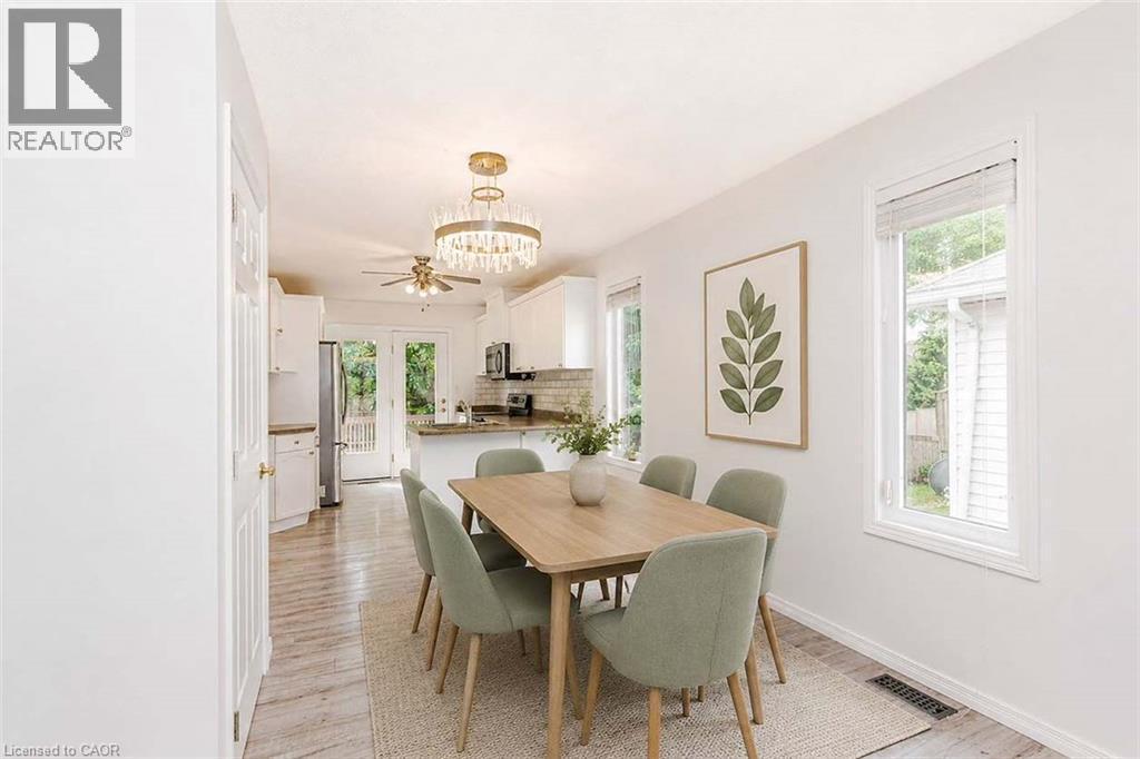 Dining area with wood-finish flooring, a contemporary chandelier, and recessed lighting - 47 Queensway Drive, Strathroy, ON - Indoor Photo Showing Dining Room