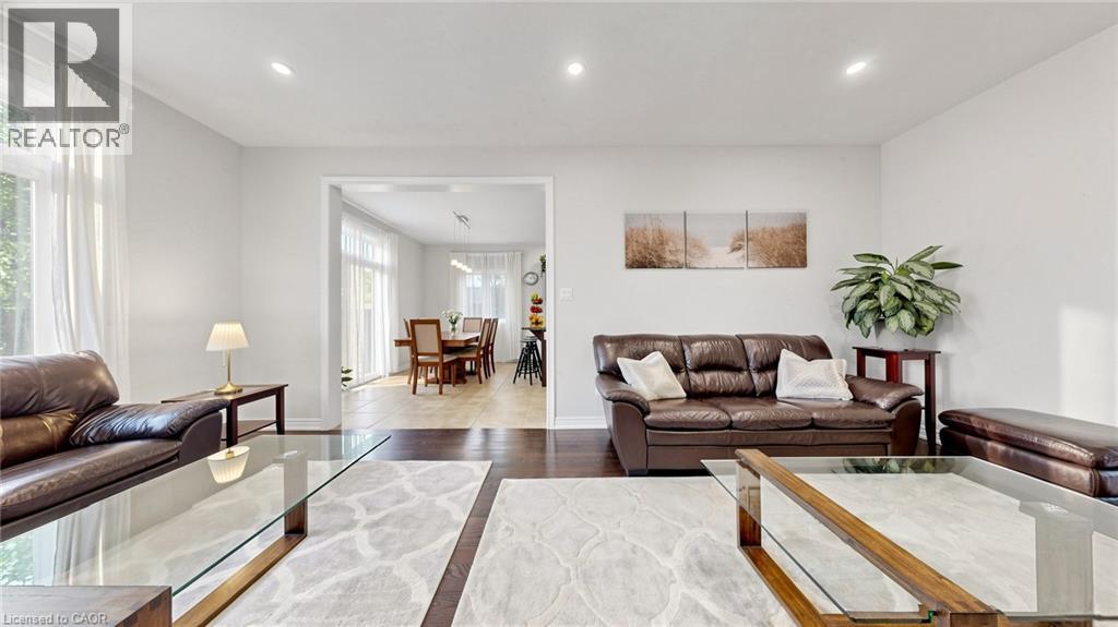 Bright living area featuring recessed lighting, dark wood-finish flooring, and ample natural light from large windows - 173 Raymond Road, Ancaster, ON - Indoor Photo Showing Living Room