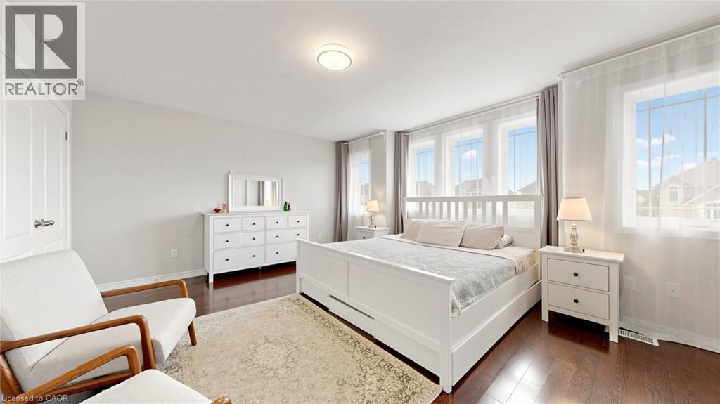Recessed lighting, wood-finish flooring, multiple windows, and a built-in closet door - 173 Raymond Road, Ancaster, ON - Indoor Photo Showing Bedroom