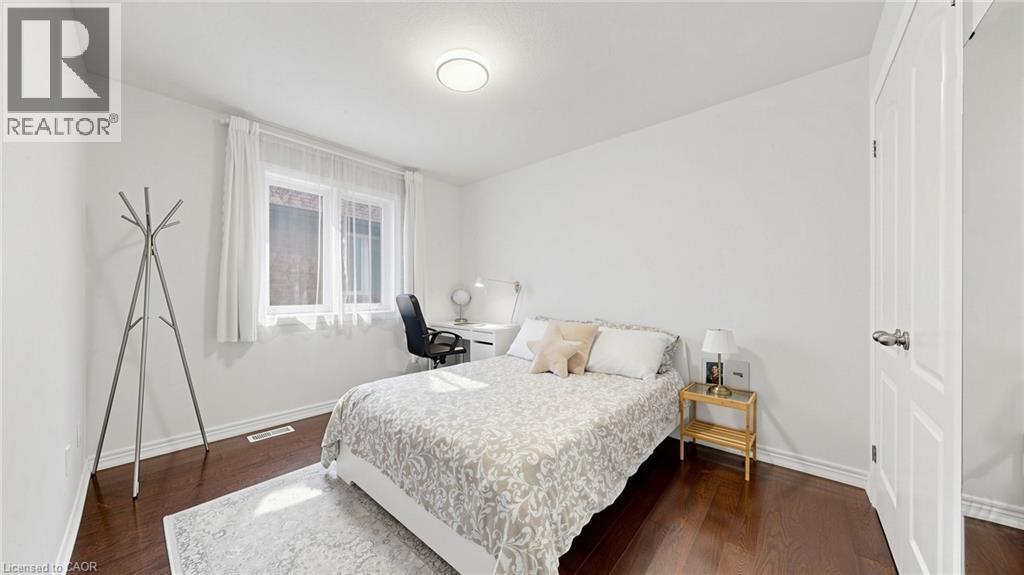 Dark wood-finish flooring, white walls, and a recessed ceiling light - 173 Raymond Road, Ancaster, ON - Indoor Photo Showing Bedroom
