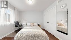 Expansive window, wood-finish flooring, white paneled doors, and a flush mount ceiling light -