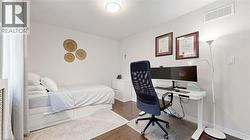 Hardwood flooring, white walls, and a ceiling-mounted light fixture -