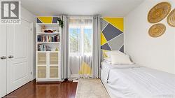 Wood-finish flooring, built-in shelving with lower cabinet storage, and a large window with natural light -