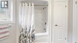 White bath-shower combination with a chrome shower head and faucet -
