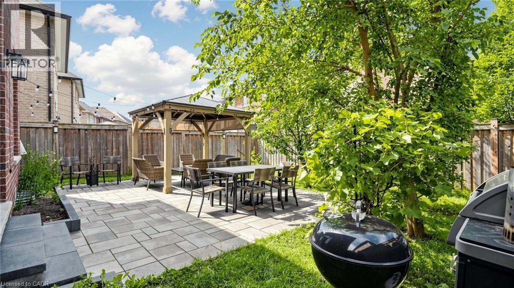 Expansive backyard featuring a paver patio, wood-framed gazebo, and mature trees - 173 Raymond Road, Ancaster, ON - Outdoor With Deck Patio Veranda