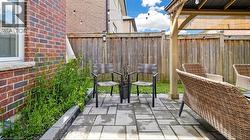 Brick exterior, raised garden bed, paver patio, wood privacy fencing, and a wood pergola -