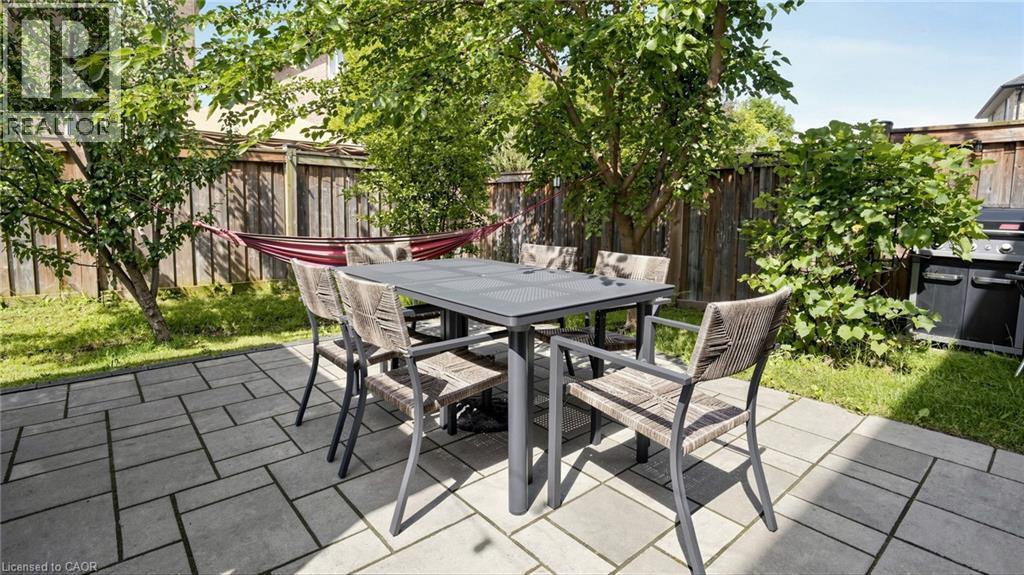 Paved patio featuring a geometric pattern and surrounding green spaces - 173 Raymond Road, Ancaster, ON - Outdoor With Deck Patio Veranda