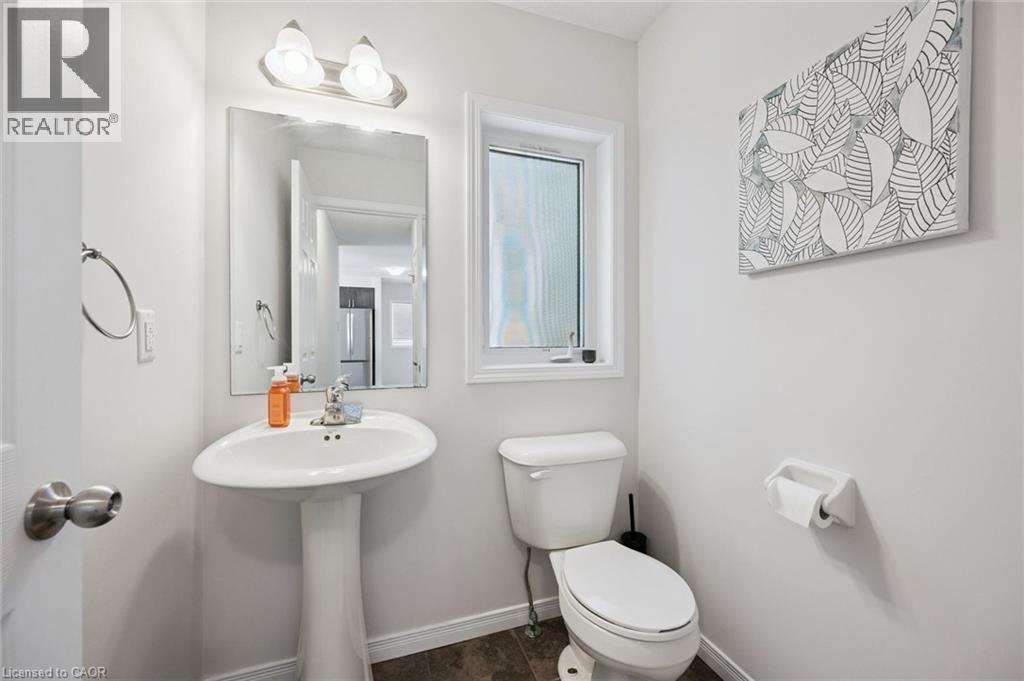 Pedestal sink with chrome faucet, framed mirror, and overhead vanity lighting - 360 Freure Drive, Cambridge, ON - Indoor Photo Showing Bathroom
