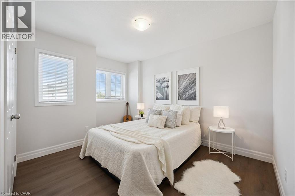 White walls with dark wood-finish flooring - 360 Freure Drive, Cambridge, ON - Indoor Photo Showing Bedroom