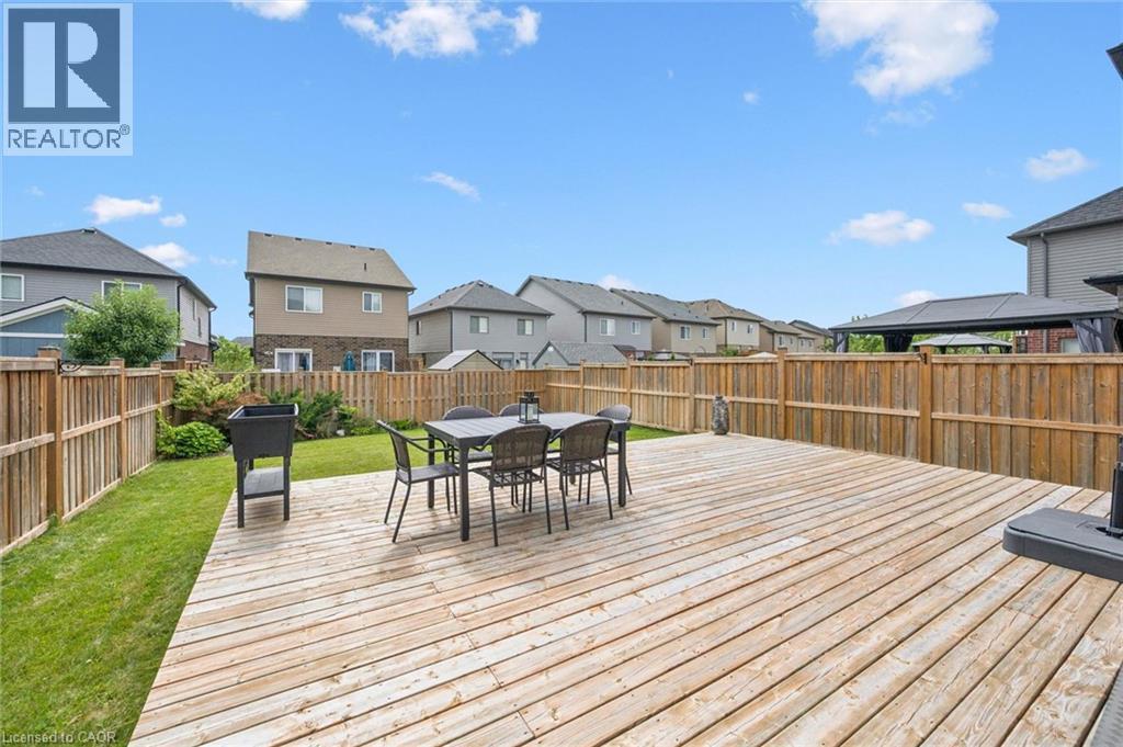 Expansive wood-plank deck with a perimeter wood fence, featuring a grassy lawn area - 360 Freure Drive, Cambridge, ON - Outdoor With Deck Patio Veranda With Exterior