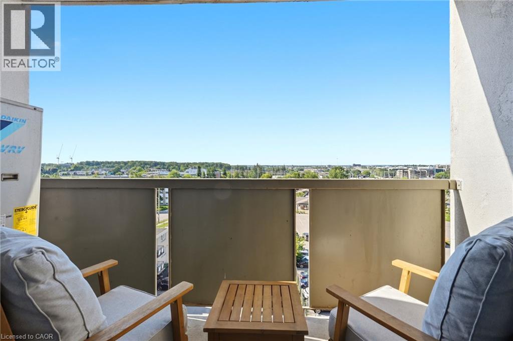 Balcony with a solid privacy barrier and an urban tree-lined horizon - 375 King Street N Unit# 708, Waterloo, ON - Outdoor With Exterior