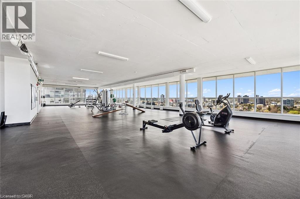 Fitness center with high ceilings, resilient flooring, and expansive windows - 375 King Street N Unit# 708, Waterloo, ON - Indoor Photo Showing Gym Room