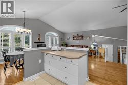 Kitchen island with white cabinetry and a light-toned countertop - 