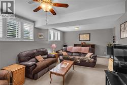 Spacious room with light gray walls, white trim, and light-colored carpet flooring - 